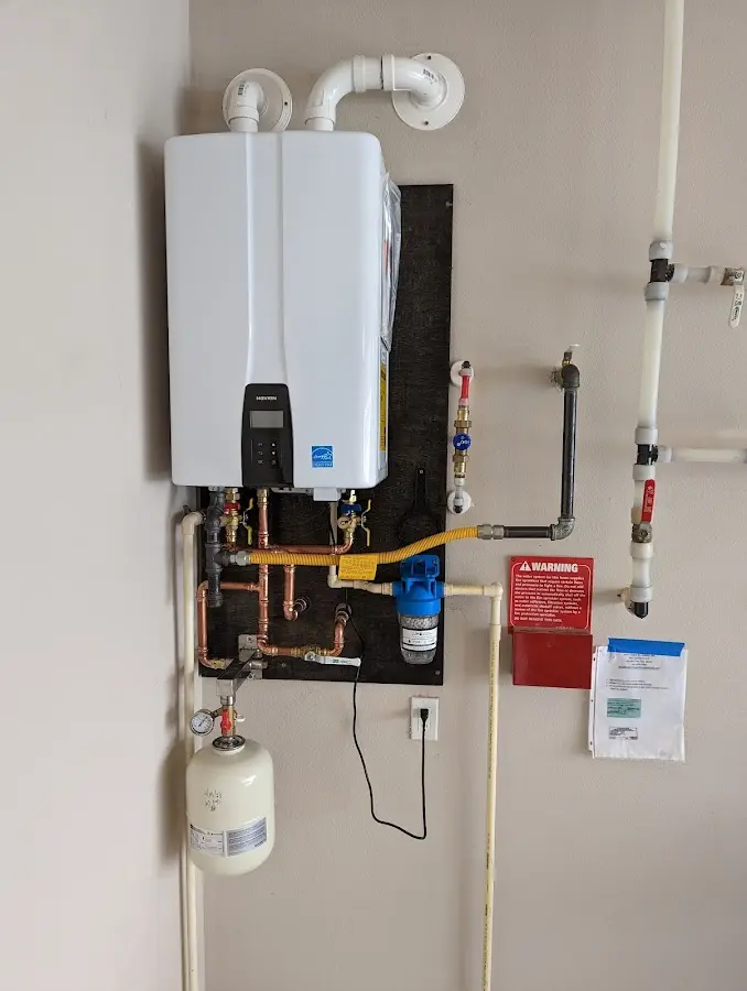 Professional plumber installing copper piping in a San Bernardino home